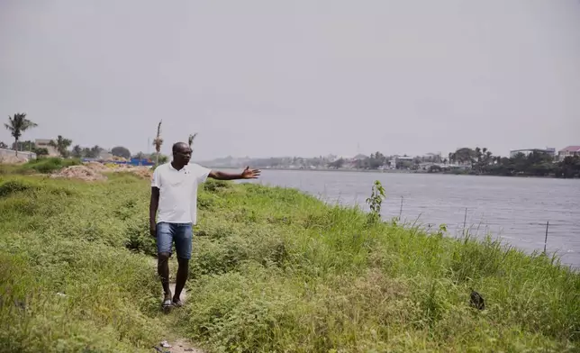 Koutoglo Kossi Mawuli, points at the lagoon where the body of Jacques Koami Koutoglo, was recovered in Lome, Togo, Monday, July 7, 2025. (AP Photo/Erick Kaglan)