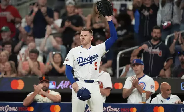 Los Angeles Dodgers Freddie Freeman waves to the crowd after leaving the game during third inning at the MLB baseball All-Star game between the American League and National League, Tuesday, July 15, 2025, in Atlanta. (AP Photo/Mike Stewart)