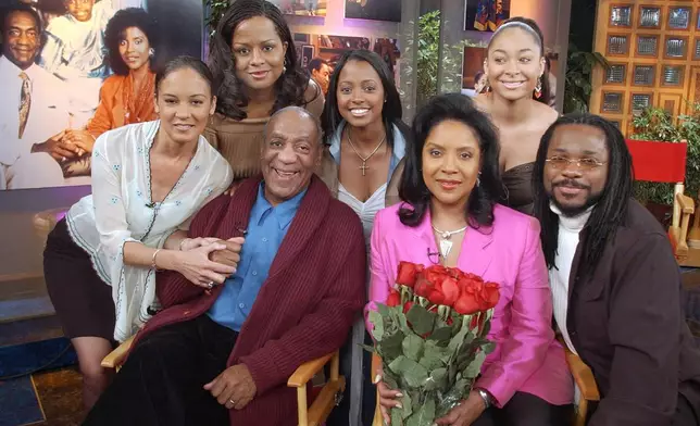 FILE - Members of Bill Cosby's television family, the Huxtables, Sabrina Le Beauf, from left, Tempest Bledsoe, Cosby, Keshia Knight Pulliam, Phylicia Rashad, Raven Symone and Malcolm-Jamal Warner, gather in NBC's Today show studio for an interview with co-host Katie Couric, Thursday, May 2, 2002, in New York. (AP Photo/Richard Drew, File)