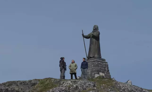 Tourists stand in front of the Statue of Hans Egede in Nuuk, Greenland, Sunday, June 22, 2025. (AP Photo/Kwiyeon Ha)