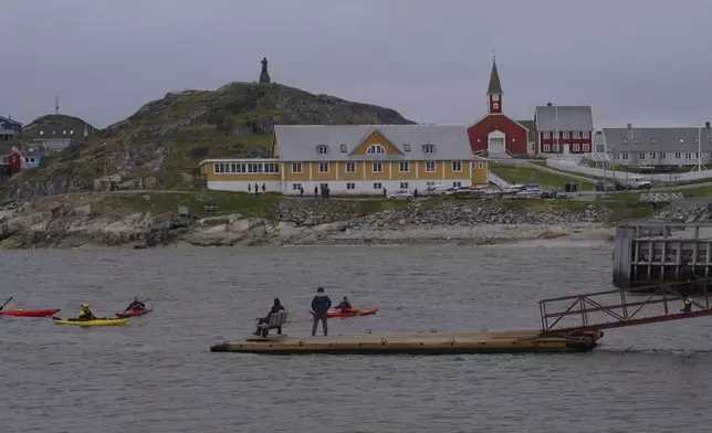 Tourists kayak at sea in front of Nuuk Cathedral in Nuuk, Greenland, Monday, June 16, 2025. (AP Photo/Kwiyeon Ha)
