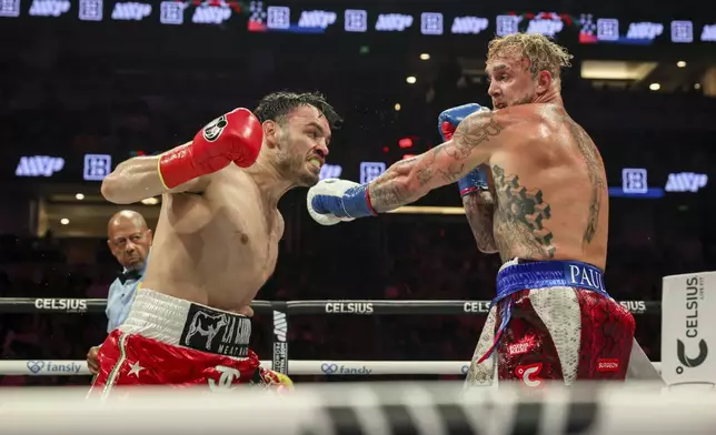 FILE - Julio Cesar Chavez Jr., left, throws a punch at Jake Paul during their cruiserweight boxing match, in Anaheim, Calif., June 28, 2025. (AP Photo/Etienne Laurent, File)