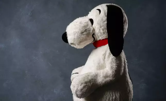A person dressed as the character Snoopy poses for a portrait to promote the 75th anniversary of "Peanuts" during Comic-Con International on Thursday, July 24, 2025, in San Diego. (AP Photo/Chris Pizzello)