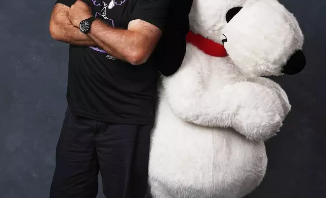Alec Baldwin, left, and a person dressed as the character Snoopy from "Peanuts" poses for a portrait to promote the 75th anniversary of "Peanuts" during Comic-Con International on Thursday, July 24, 2025, in San Diego. (AP Photo/Chris Pizzello)