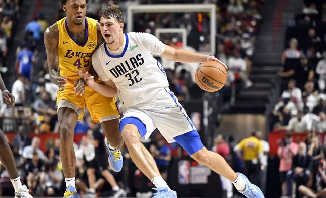 Dallas Mavericks forward Cooper Flagg (32) drives the ball against Los Angeles Lakers guard DaJaun Gordon (45) during the second half of an NBA summer league basketball game Thursday, July 10, 2025, in Las Vegas. (AP Photo/David Becker)