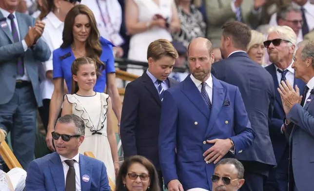 Britain's Prince William, right, Kate, Princess of Wales, Prince George and Princess Charlotte arrive at the Royal Box to watch Jannik Sinner of Italy and Carlos Alcaraz of Spain during their men's singles final match at the Wimbledon Tennis Championships in London, Sunday, July 13, 2025.(AP Photo/Kirsty Wigglesworth)