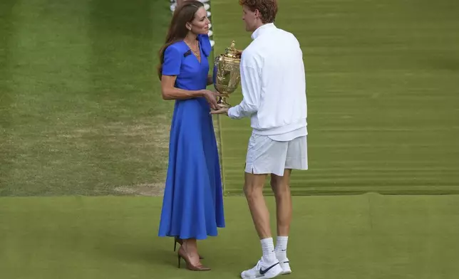 Italy's Jannik Sinner receives the trophy from Kate, Princess of Wales, after beating Carlos Alcaraz of Spain to win the men's singles final at the Wimbledon Tennis Championships in London, Sunday, July 13, 2025. (AP Photo/Joanna Chan)