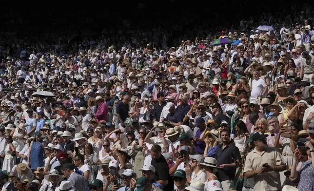 Crowds pack the stands of Centre Court before Italy's Jannik Sinner plays Carlos Alcaraz of Spain in the men's singles final at the Wimbledon Tennis Championships in London, Sunday, July 13, 2025. (AP Photo/Kin Cheung)