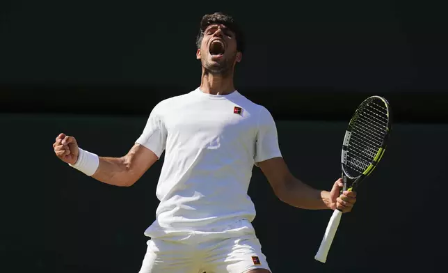 Carlos Alcaraz of Spain celebrates winning the men's semifinal singles match against Taylor Fritz of the U.S. at the Wimbledon Tennis Championships in London, Friday, July 11, 2025.(AP Photo/Kirsty Wigglesworth)