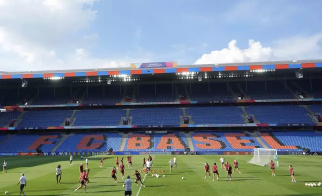 Players exercise on the pitch during a training session of Switzerland's team ahead of their the Euro 2025, group A, soccer match with Norway, at St. Jakob-Park in Basel, Switzerland, Tuesday, July 1, 2025. (AP Photo/Martin Meissner)