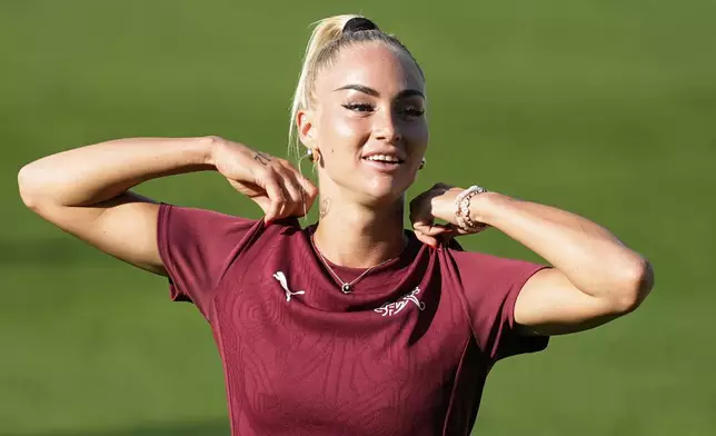 Switzerland's Alisha Lehmann adjusts her shirt during a training session of Switzerland's team ahead of their the Euro 2025, group A, soccer match with Norway, at St. Jakob-Park in Basel, Switzerland, Tuesday, July 1, 2025. (AP Photo/Martin Meissner)