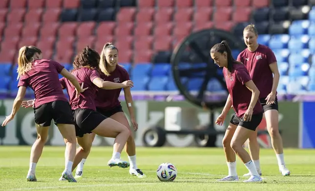 Switzerland's Riola Xhemaili, 2nd right, eyes the ball during a training session of Switzerland's team ahead of their the Euro 2025, group A, soccer match with Norway, at St. Jakob-Park in Basel, Switzerland, Tuesday, July 1, 2025. (AP Photo/Martin Meissner)