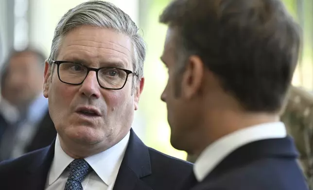 British Prime Minister Keir Starmer and French President Emmanuel Macron, right, talk during a joint military visit to the MARCOM centre, maritime command centre in Northwood, London, Thursday July 10, 2025. (Leon Neal/Pool Photo via AP)