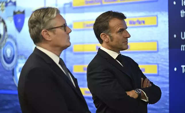 British Prime Minister Keir Starmer and French President Emmanuel Macron, right, look at screens during a joint military visit to the MARCOM centre, maritime command centre in Northwood, London, Thursday July 10, 2025. (Leon Neal/Pool Photo via AP)