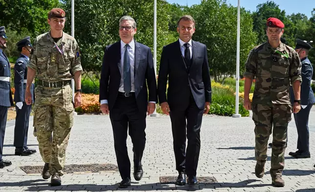 British Prime Minister Keir Starmer, centre left, and French President Emmanuel Macron, centre right, arrive for a joint military visit to the MARCOM centre, maritime command centre in Northwood, London, Thursday July 10, 2025. (Leon Neal/Pool Photo via AP)
