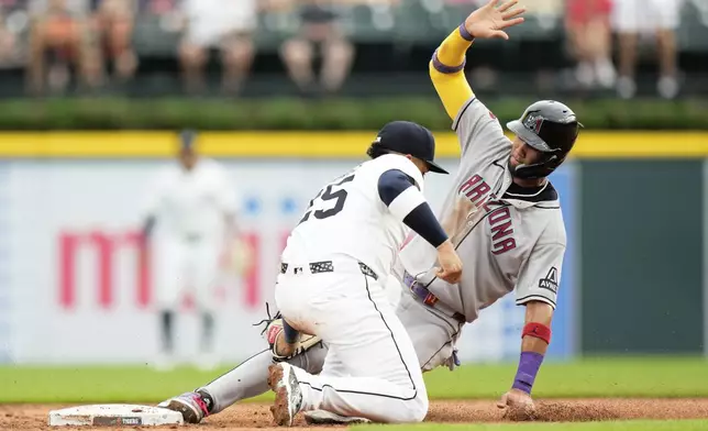 Detroit Tigers second baseman Gleyber Torres, left, catches Arizona Diamondbacks' Lourdes Gurriel Jr. who was trying to steal second during the second inning of a baseball game Monday, July 28, 2025, in Detroit. (AP Photo/Ryan Sun)