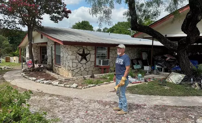 Daniel Olivas stands outside his flood-damaged home in Kerrville, Texas, Saturday, July 12, 2025. (AP Photo/Gabriela Aoun Angueira)