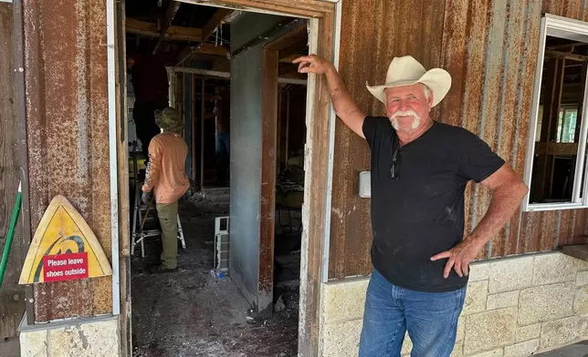 Volunteer Dave Calame stands outside a home he is helping clean after flooding in Comfort, Texas, on Saturday, July 12, 2025. (AP Photo/Gabriela Aoun Angueira)