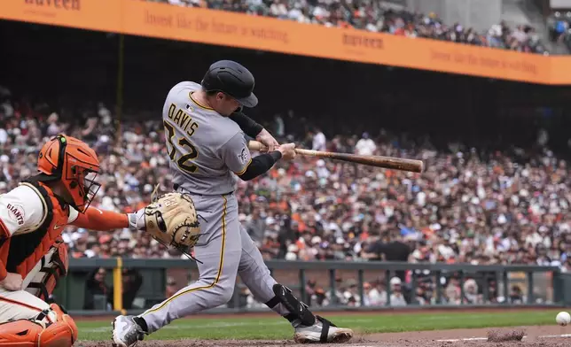 Pittsburgh Pirates' Henry Davis (32) drives in a run with a groundout to San Francisco Giants pitcher Ryan Walker during the 10th inning of a baseball game Wednesday, July 30, 2025, in San Francisco. Oneil Cruz scored and Davis was out at first on the play. (AP Photo/Godofredo A. Vásquez)