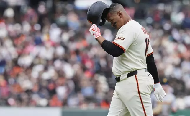 San Francisco Giants' Rafael Devers walks to the dugout after hitting a fly ball to Pittsburgh Pirates left fielder Jack Suwinski to end the eighth inning of a baseball game Wednesday, July 30, 2025, in San Francisco. (AP Photo/Godofredo A. Vásquez)