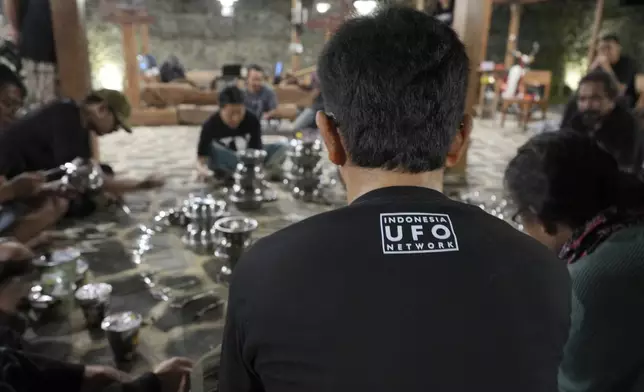 Participants experiment with sound created using various aluminum bowls and utensils during the Indonesia UFO Festival, in Yogyakarta, Indonesia, Thursday, July 24, 2025. (AP Photo/Dita Alangkara)