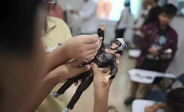Children take part in a "space suit design workshop" held as part of the Indonesia UFO Festival in Yogyakarta, Indonesia,Friday, July 25, 2025. (AP Photo/Dita Alangkara)