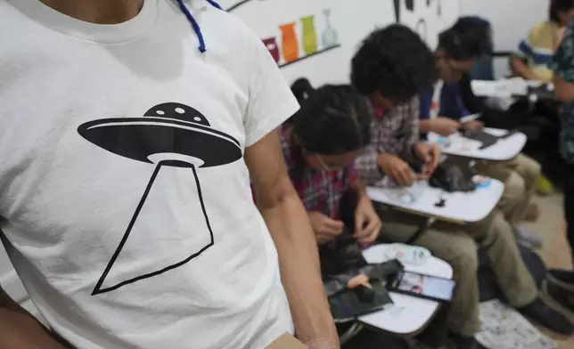 People participate in a "space suit design workshop" held as part of the Indonesia UFO Festival in Yogyakarta, Indonesia,Friday, July 25, 2025. (AP Photo/Dita Alangkara)