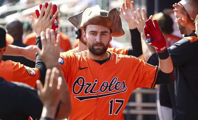 Baltimore Orioles' Colton Cowser high-fives teammates in the dugout after hitting a two-run home run in the fourth inning of a baseball game against the Atlanta Braves, Saturday, July 5, 2025, in Atlanta. (AP Photo/Colin Hubbard)