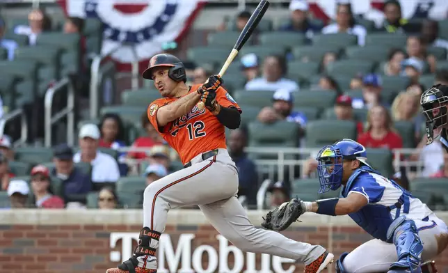 Baltimore Orioles' Ramón Laureano (12) hits an RBI double in the 10th inning of a baseball game against the Atlanta Braves, Saturday, July 5, 2025, in Atlanta. (AP Photo/Colin Hubbard)