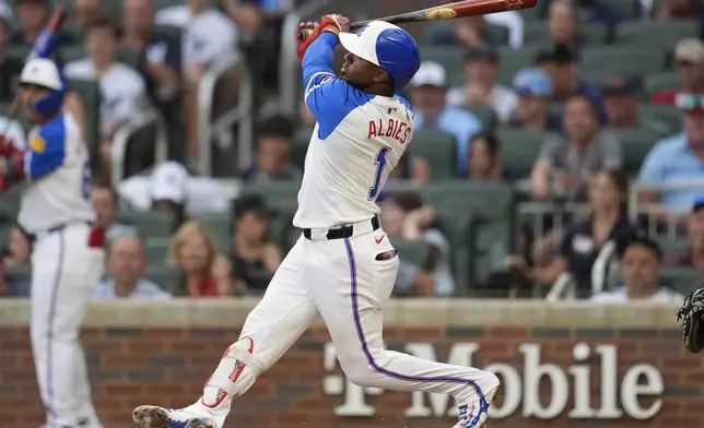 Atlanta Braves second baseman Ozzie Albies (1) hits a three-run home run against the New York Yankees in the fourth inning of a baseball game, Saturday, July 19, 2025, in Atlanta. (AP Photo/Mike Stewart)