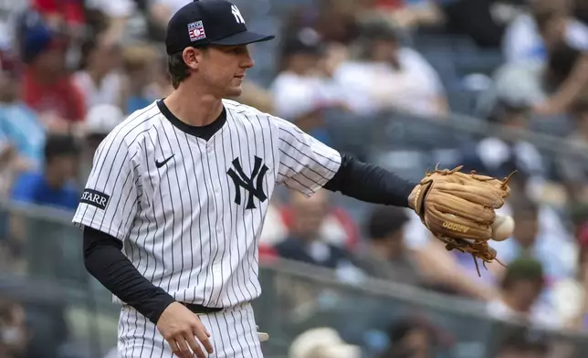 New York Yankees third baseman Ryan McMahon catches a ball during the second inning of a baseball game against the Philadelphia Phillies, Sunday, July 27, 2025, in New York. (AP Photo/Angelina Katsanis)