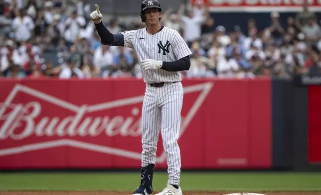 New York Yankees' Ryan McMahon celebrates after his two-run double during the second inning of a baseball game against the Philadelphia Phillies, Sunday, July 27, 2025, in New York. (AP Photo/Angelina Katsanis)