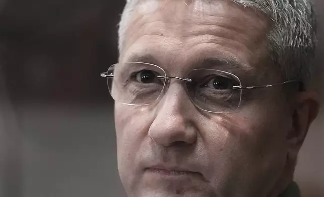 FILE - Timur Ivanov, Russia's former deputy defense minister facing corruption charges, stands in the defendant's cage before a hearing, in the Moscow City Court in Moscow, Russia, on Monday, March 24, 2025. (AP Photo/Pavel Bednyakov, File)