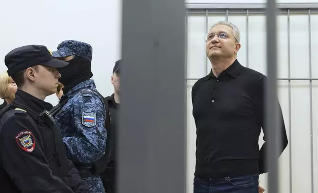 Timur Ivanov, Russia's former deputy defense minister facing corruption charges, right, stands in the defendant's cage before a hearing, in the Moscow City Court in Moscow, Russia, Tuesday, July 1, 2025. (AP Photo)