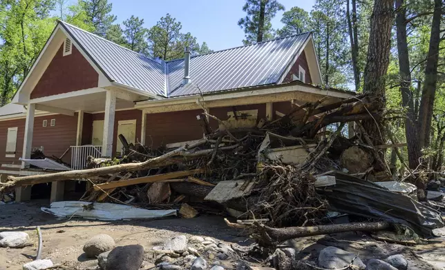 Residents of the town of Ruidoso, N.M., came back to their neighborhood to find what was left of their homes a day after major flooding washed away properties and RV's on Tuesday, along the Rio Ruidoso, Wednesday, July 9, 2025, in Ruidoso, N.M. (AP Photo/Roberto E. Rosales)