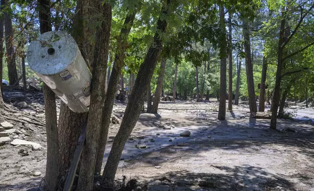 A water heater got wedged between trees near the downtown area in the town of Ruidoso, N.M., Wednesday, July 9, 2025, during major flash flooding yesterday. (AP Photo/Roberto E. Rosales)