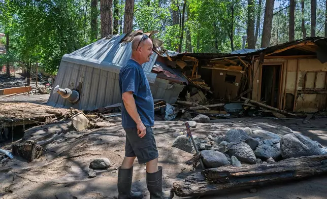 Dan Privett stands on what would be the front of his house, Wednesday, July 9, 2025, in Ruidoso, N.M., which was destroyed in the flash floods yesterday that hit the town. (AP Photo/Roberto E. Rosales)