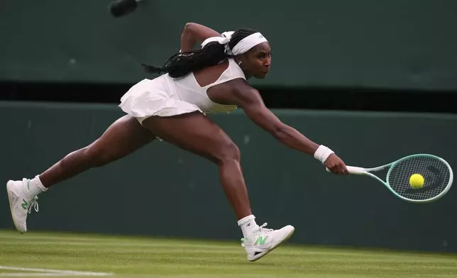 Coco Gauff of the U.S. returns the ball to Dayana Yastremska of Ukraine during their first round women's single match at the Wimbledon Tennis Championships in London, Tuesday, July 1, 2025.(AP Photo/Kirsty Wigglesworth)
