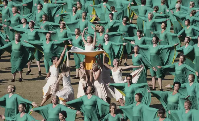 Participants perform during the Estonian Song and Dance Celebration "Iseoma" at the Kalev Stadium in Tallinn, Estonia, Friday, July 4, 2025. (AP Photo/Sergei Grits)