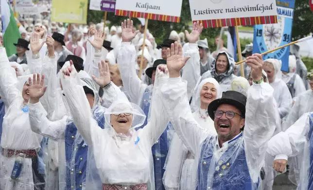 People take part in the "Iseoma" Song and Dance Celebration, in Tallinn, Estonia, Saturday, July 5, 2025. (AP Photo/Sergei Grits)
