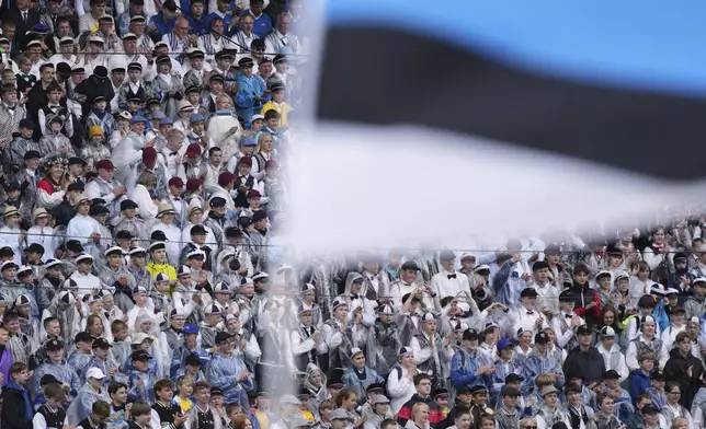 Choir singers attend the "Iseoma" Song and Dance Celebration at the Song Festival Grounds in Tallinn, Estonia, on Sunday, July 6, 2025. (AP Photo/Sergei Grits)