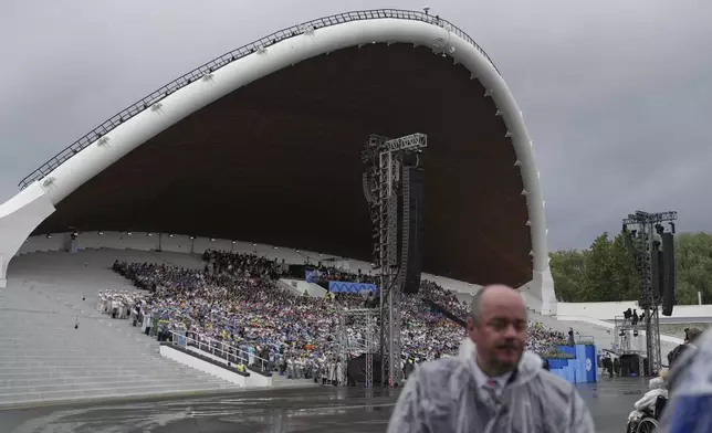 Choir singers attend the "Iseoma" Song and Dance Celebration at the Song Festival Grounds in Tallinn, Estonia, on Sunday, July 6, 2025. (AP Photo/Sergei Grits)