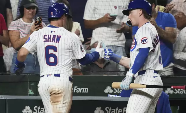 Chicago Cubs' Matt Shaw (6) celebrates with Pete Crow-Armstrong after scoring on a one-run single by Seiya Suzuki, of Japan, during the seventh inning of a baseball game against the Kansas City Royals in Chicago, Tuesday, July 22, 2025. (AP Photo/Nam Y. Huh)