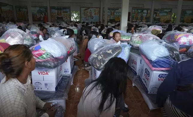 Local villagers wait to receive supplies donated by a charity, in Srey Snam district, Siem Reap province, Cambodia, Monday, July 28, 2025, amid the fighting between Thailand and Cambodia. (AP Photo/Heng Sinith)