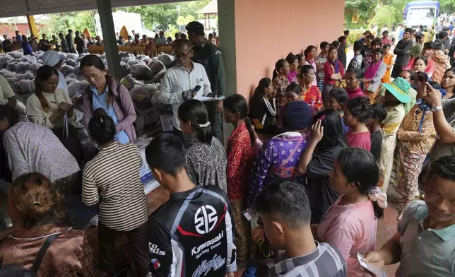 Local villagers wait to receive supplies donated by a charity, in Srey Snam district, Siem Reap province, Cambodia, Monday, July 28, 2025, amid the fighting between Thailand and Cambodia. (AP Photo/Heng Sinith)