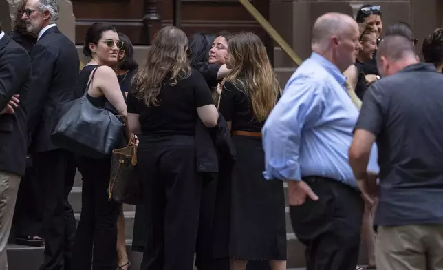 People embrace each other following a funeral of Julia Hyman, associate at Rudin Management Company, one of the victims of Monday's deadly shooting, Wednesday, July 30, 2025, in New York. (AP Photo/Yuki Iwamura)