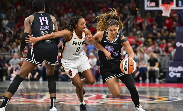 Golden State Valkyries' Veronica Burton (22) is defended by Indiana Fever's Kelsey Mitchell (0) during the first half of a WNBA basketball game, Wednesday, July 9, 2025, in Indianapolis. (AP Photo/Doug McSchooler)
