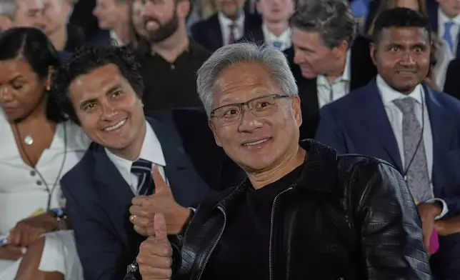 Nvidia CEO Jensen Huang poses for a photo before President Donald Trump speaks during an AI summit at the Andrew W. Mellon Auditorium, Wednesday, July 23, 2025, in Washington. (AP Photo/Julia Demaree Nikhinson)