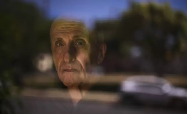Kamran Afary, an associate professor of communication at California State University, Los Angeles, who immigrated from Iran in the 1970s, stands for a photo in the "Tehrangeles" neighborhood of Los Angeles Sunday, June 29, 2025. (AP Photo/Jae C. Hong)
