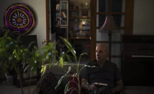 Kamran Afary, an associate professor of communication at California State University, Los Angeles, who immigrated from Iran in the 1970s, sits for a photo in the "Tehrangeles" neighborhood of Los Angeles Sunday, June 29, 2025. (AP Photo/Jae C. Hong)